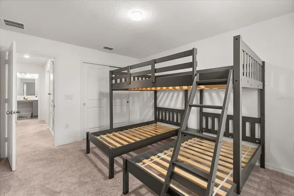 a bed sitting in a bedroom next to a window