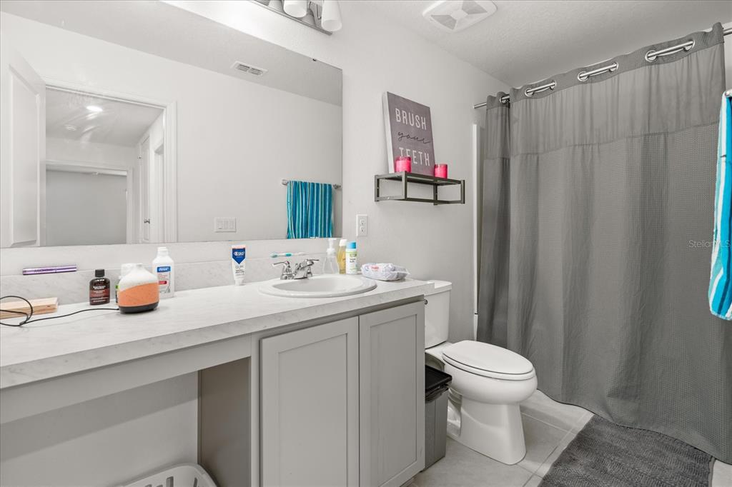 1470 Geranium Drive Mascotte, FL 34753 - Photo 19 of 23 a bathroom with a sink a toilet and a mirror