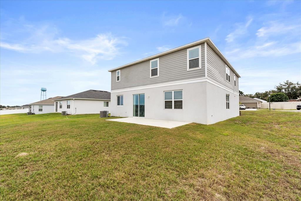 1470 Geranium Drive Mascotte, FL 34753 - Photo 22 of 23 a view of a house with a yard