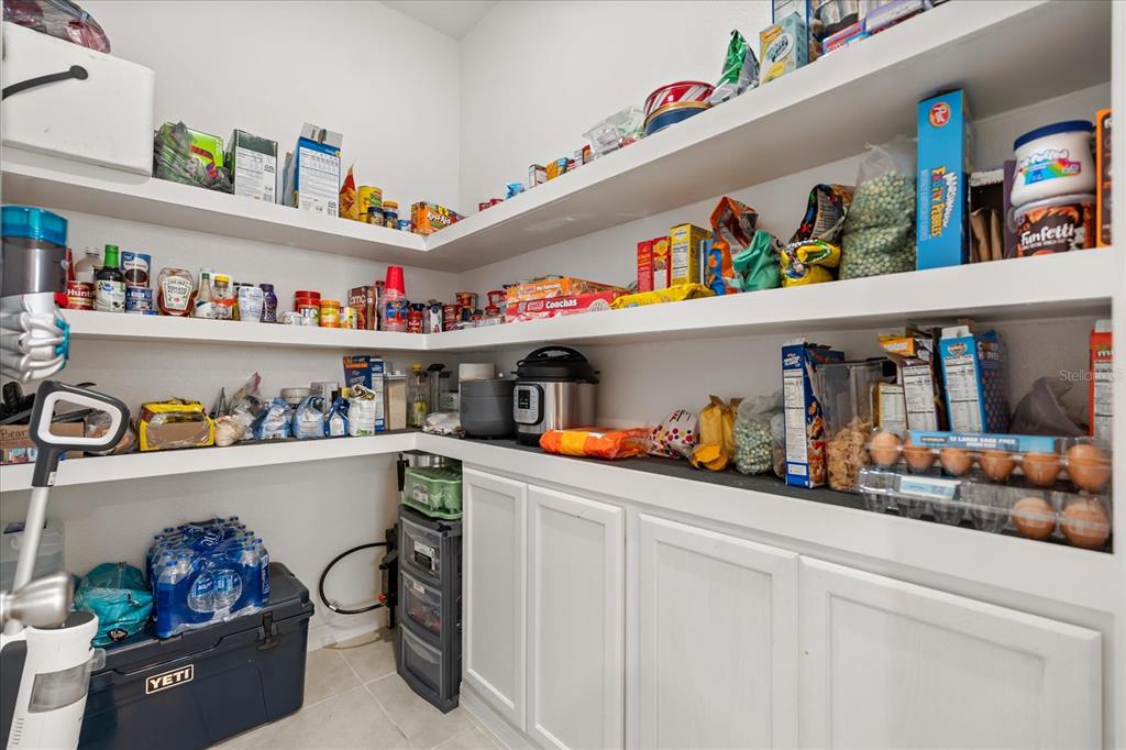 1470 Geranium Drive Mascotte, FL 34753 - Photo 6 of 23 a utility room with lots of clutter and cabinets