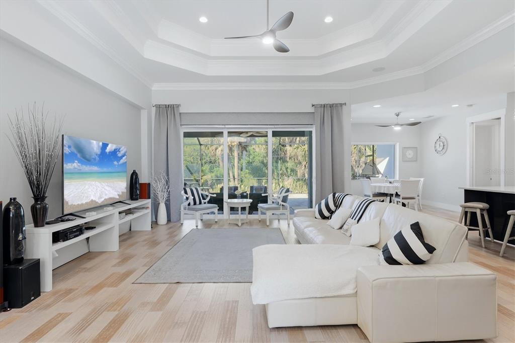 1112 Seneca Road Venice, FL 34293 - Photo 13 of 50 a living room with furniture a flat screen tv and a large window