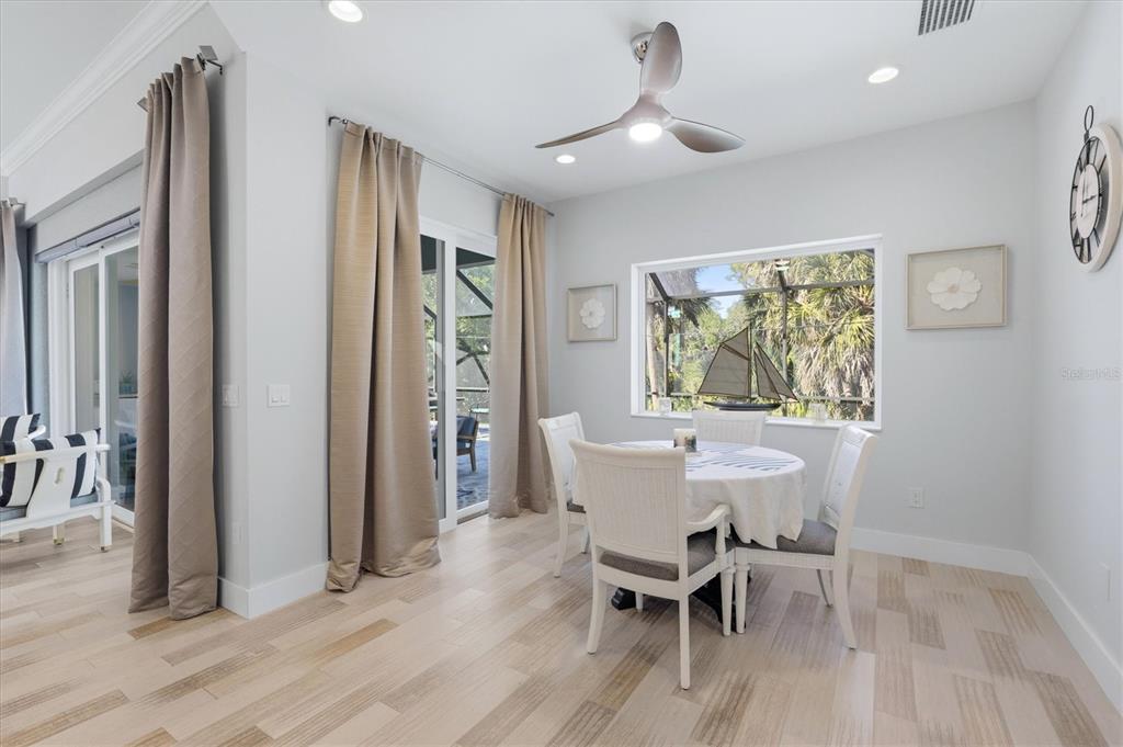 1112 Seneca Road Venice, FL 34293 - Photo 19 of 50 a view of a dining room with furniture window and wooden floor