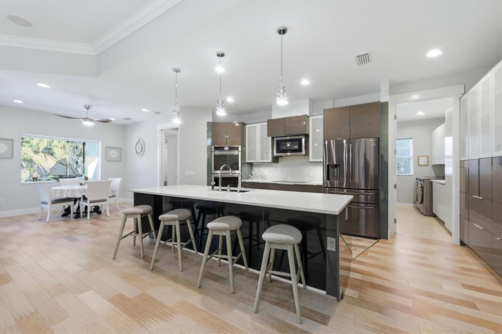 1112 Seneca Road Venice, FL 34293 - Photo 20 of 50 a large kitchen with a table and chairs