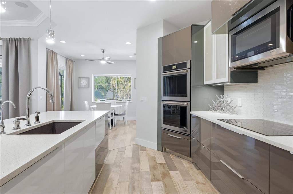 1112 Seneca Road Venice, FL 34293 - Photo 21 of 50 a kitchen with stainless steel appliances granite countertop a sink and a microwave
