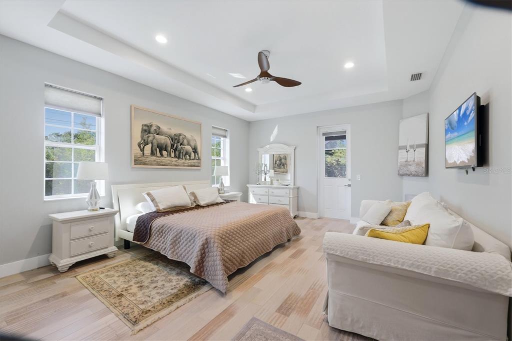 1112 Seneca Road Venice, FL 34293 - Photo 24 of 50 a bedroom with a large bed and a couch