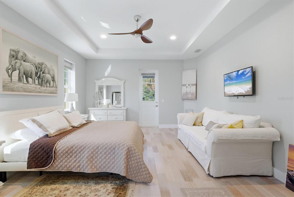 1112 Seneca Road Venice, FL 34293 - Photo 25 of 50 a spacious bedroom with a bed and a couch