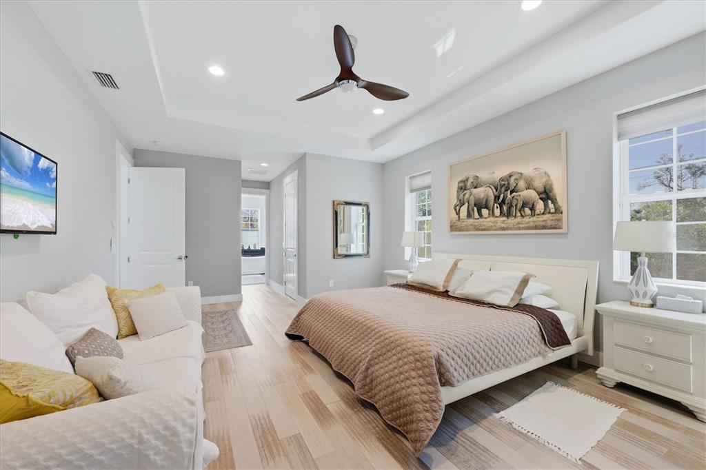 1112 Seneca Road Venice, FL 34293 - Photo 26 of 50 a bedroom with a large bed and a couch