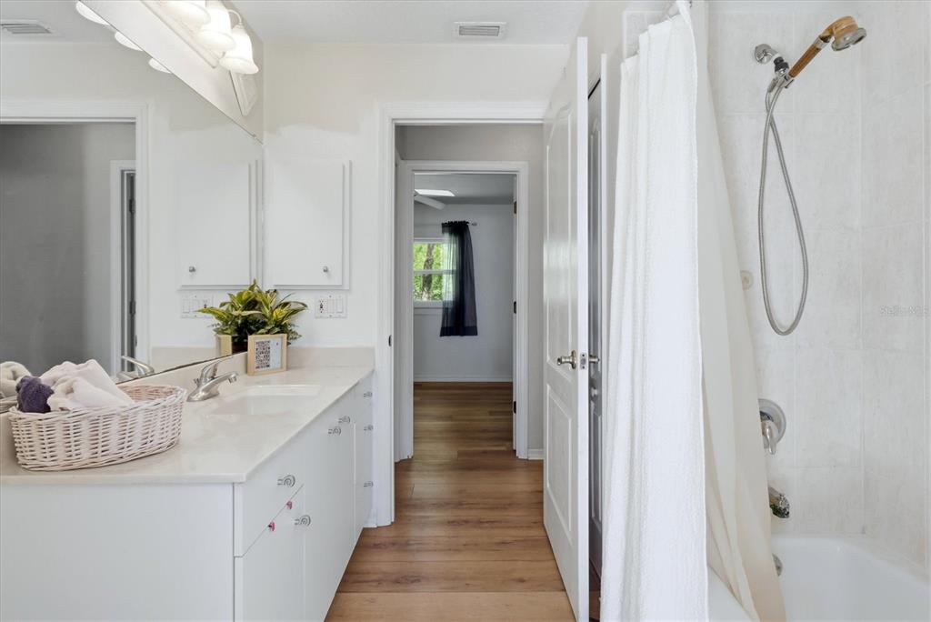 1112 Seneca Road Venice, FL 34293 - Photo 33 of 50 a bathroom with a granite countertop sink vanity and a mirror