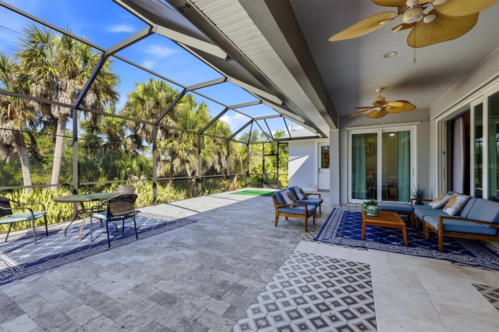 1112 Seneca Road Venice, FL 34293 - Photo 38 of 50 a living room with furniture and a floor to ceiling window