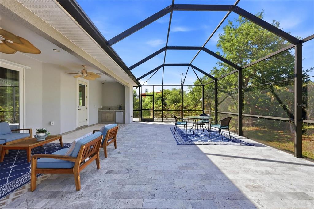1112 Seneca Road Venice, FL 34293 - Photo 40 of 50 a view of a patio with a table and chairs under an umbrella