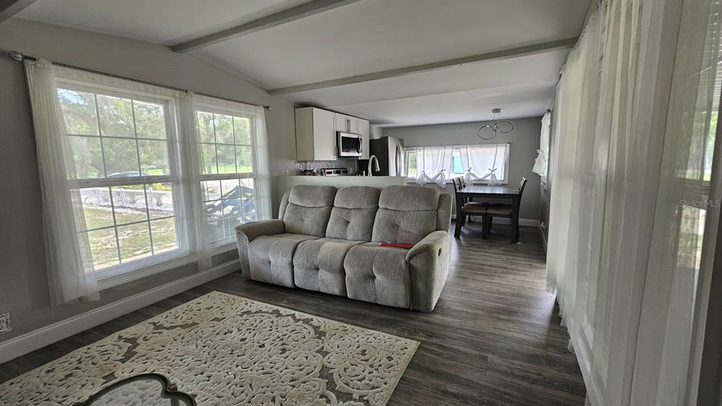 7127 West Grover Cleveland Boulevard, Unit 48 Homosassa, FL 34446 - Photo 14 of 18 a living room with furniture and a window