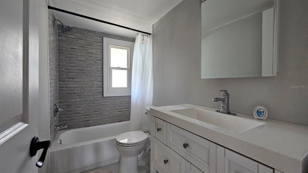 7127 West Grover Cleveland Boulevard, Unit 48 Homosassa, FL 34446 - Photo 17 of 18 a bathroom with a sink a toilet and bathtub