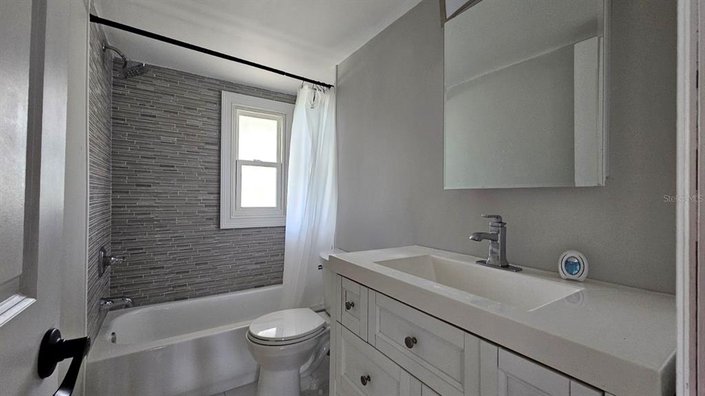 7127 West Grover Cleveland Boulevard, Unit 48 Homosassa, FL 34446 - Photo 18 of 18 a bathroom with a sink a toilet and shower