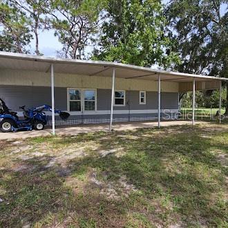 7127 West Grover Cleveland Boulevard, Unit 48 Homosassa, FL 34446 - Photo 7 of 18 a view of a house with backyard and sitting area
