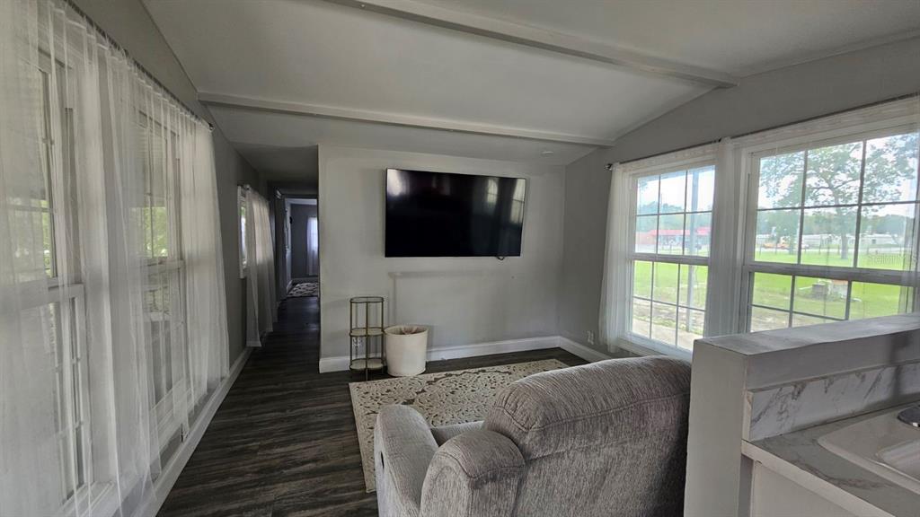 7127 West Grover Cleveland Boulevard, Unit 48 Homosassa, FL 34446 - Photo 10 of 18 a living room with furniture and a flat screen tv
