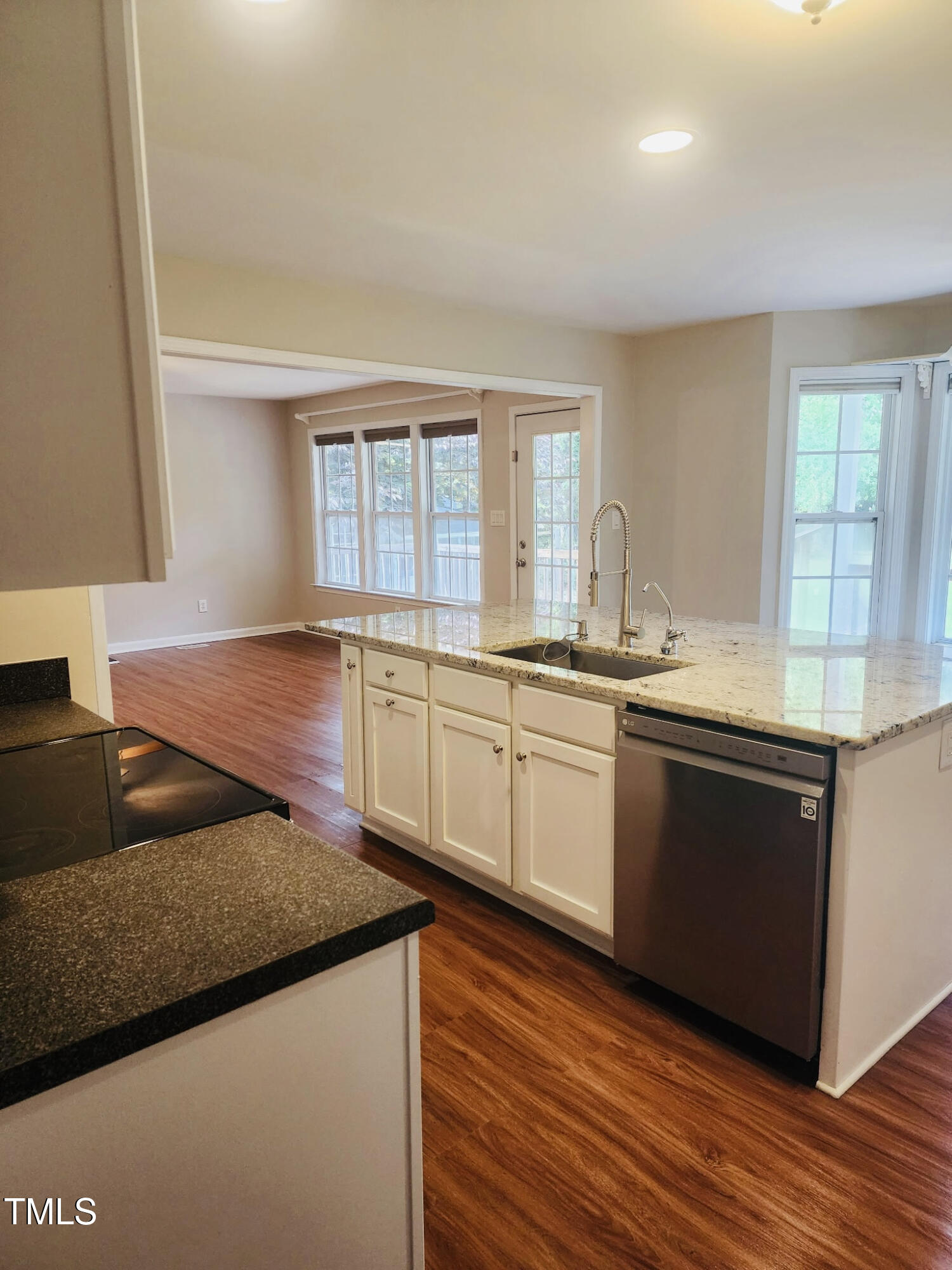 133 Rustic Lane Smithfield, NC 27577 - Photo 10 of 24 a kitchen with granite countertop a sink cabinets and wooden floor