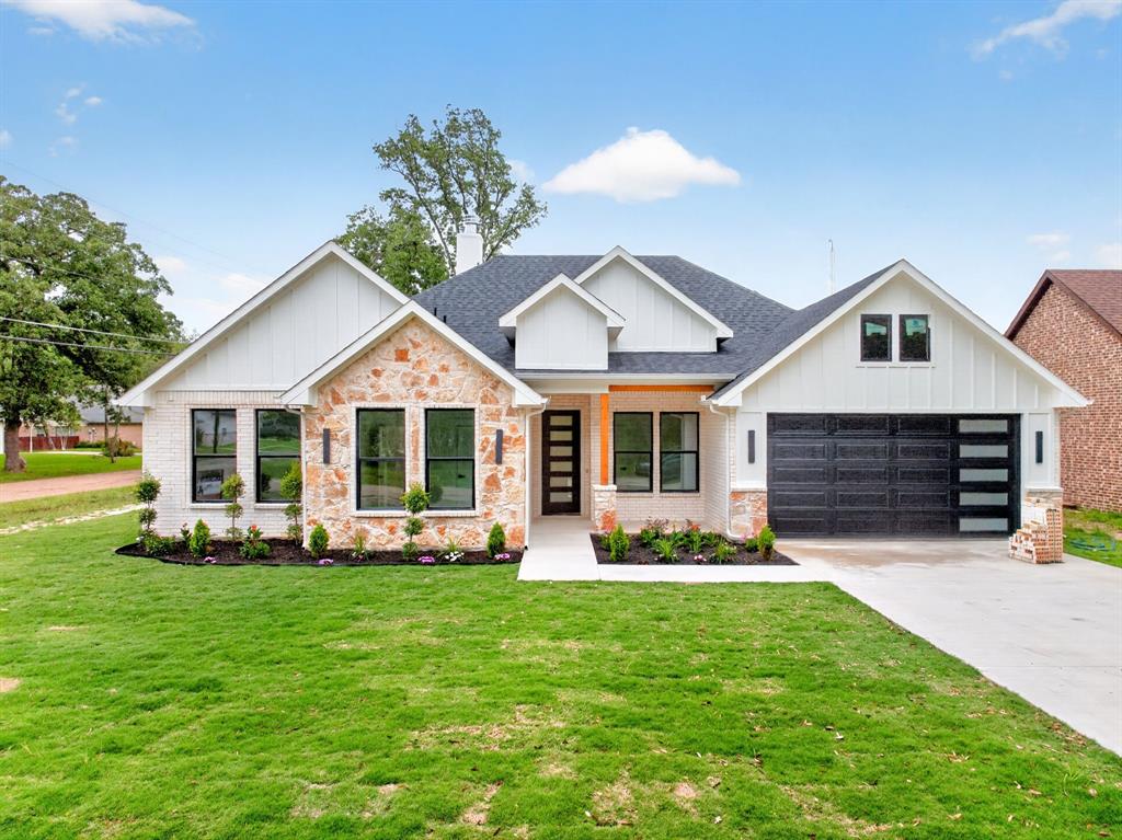120 Springwood Road Enchanted Oaks, TX 75156 - Photo 2 of 37 Modern farmhouse exterior featuring white brick and natural stone accents