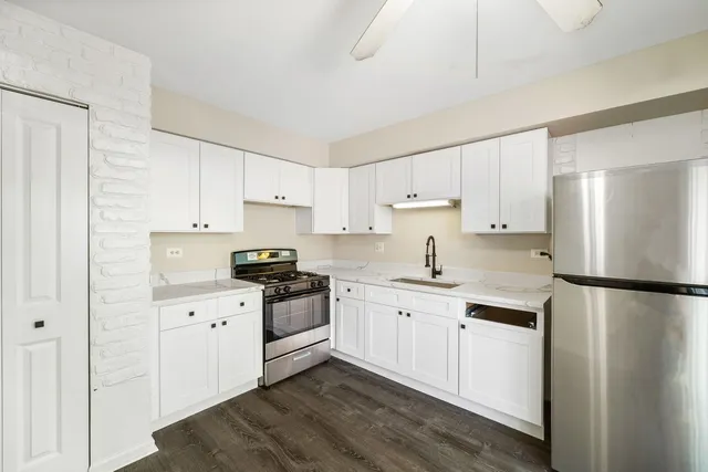 a kitchen with stainless steel appliances a refrigerator sink and cabinets