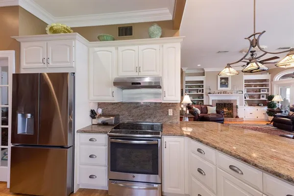 a bedroom with furniture and a large window