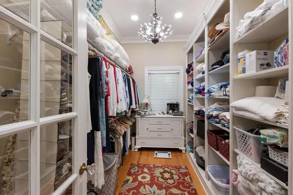 a bedroom with furniture and a large window