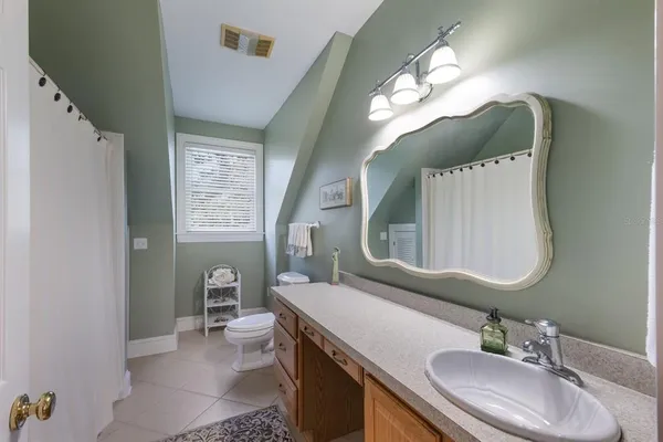 a kitchen with white cabinets and refrigerator
