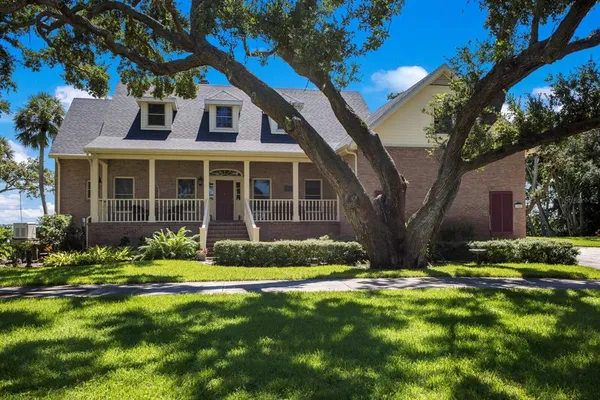 view of a house with a yard and garden