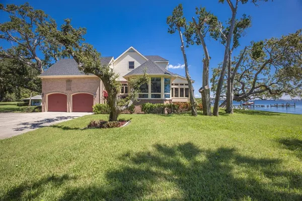 a view of yard with swimming pool and trees in the background