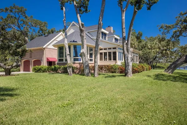 a view of a house with a tree in a yard