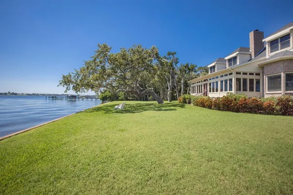an aerial view of a houses with a lake