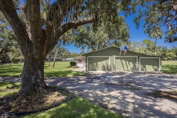 an empty room with wooden floor and yard