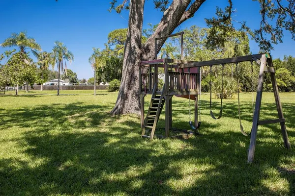 an aerial view of residential houses with outdoor space and ocean view