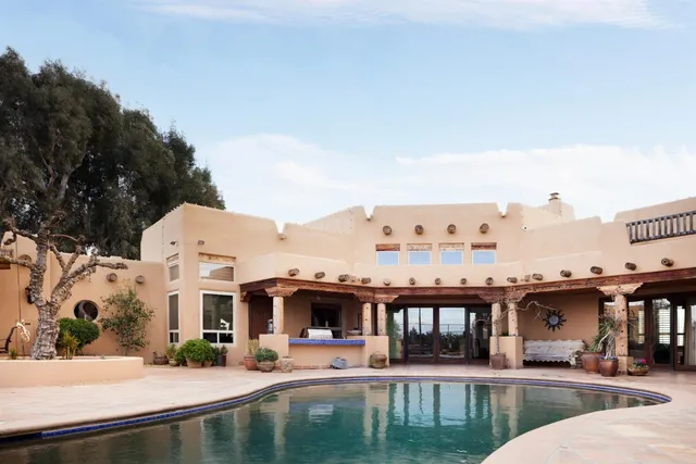 a building outdoor space with patio furniture and potted plants