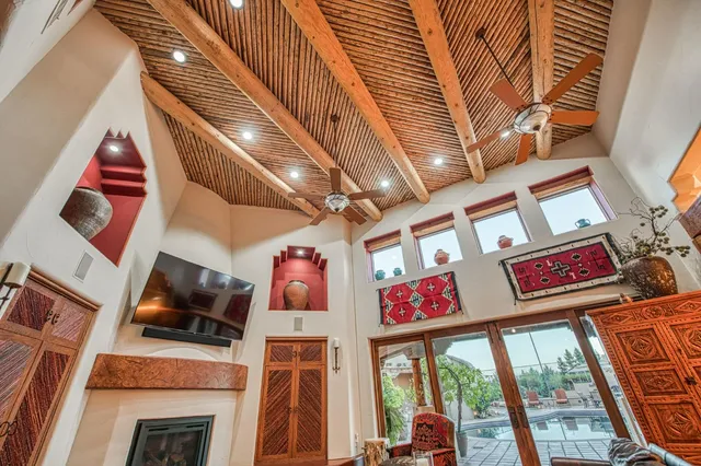 a living room with furniture a rug and a chandelier