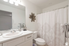 8254 Cascade Vw Way Magna, UT 84044 - Photo 10 of 12 White vanity with a single basin sink, chrome faucet, and overhead three-bulb vanity light
