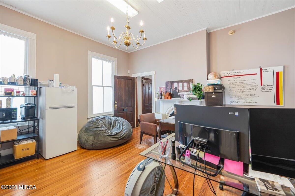 461 Pursley Street Macon, GA 31201 - Photo 5 of 25 a bedroom with a bed and a chandelier
