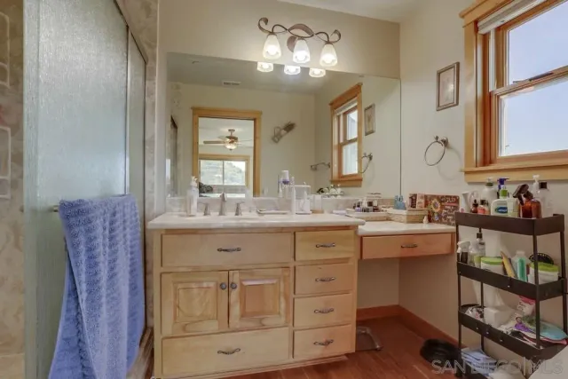 a bathroom with a double vanity sink and a mirror