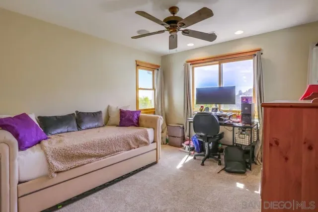a living room with a bed furniture and a window