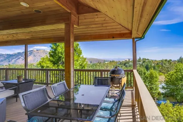 a view of a balcony with wooden floor and outdoor seating