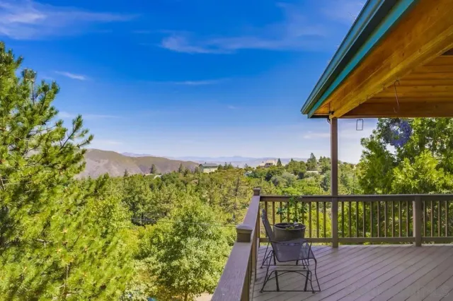 a view of a chairs and table on the wooden deck