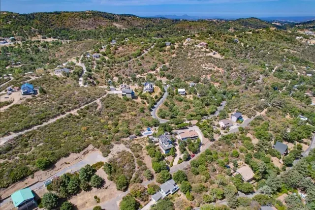 an aerial view of residential houses with outdoor space