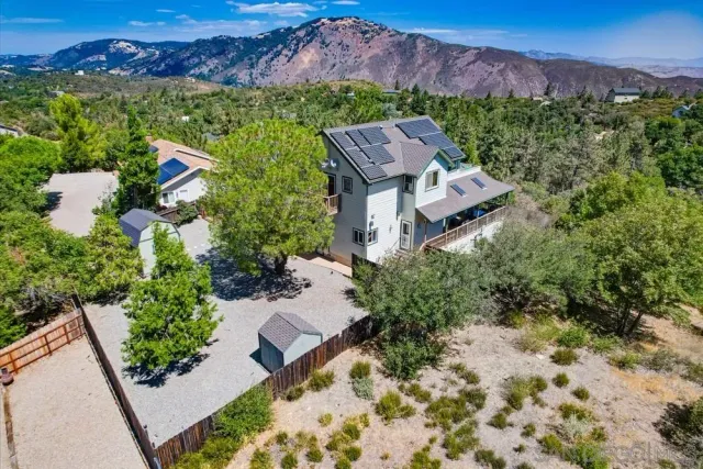 an aerial view of a house with garden space and a street view