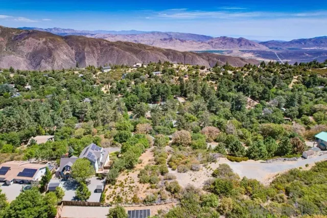 a view of a lush green hillside and houses