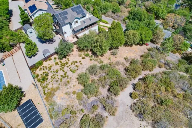 an aerial view of a house with a yard