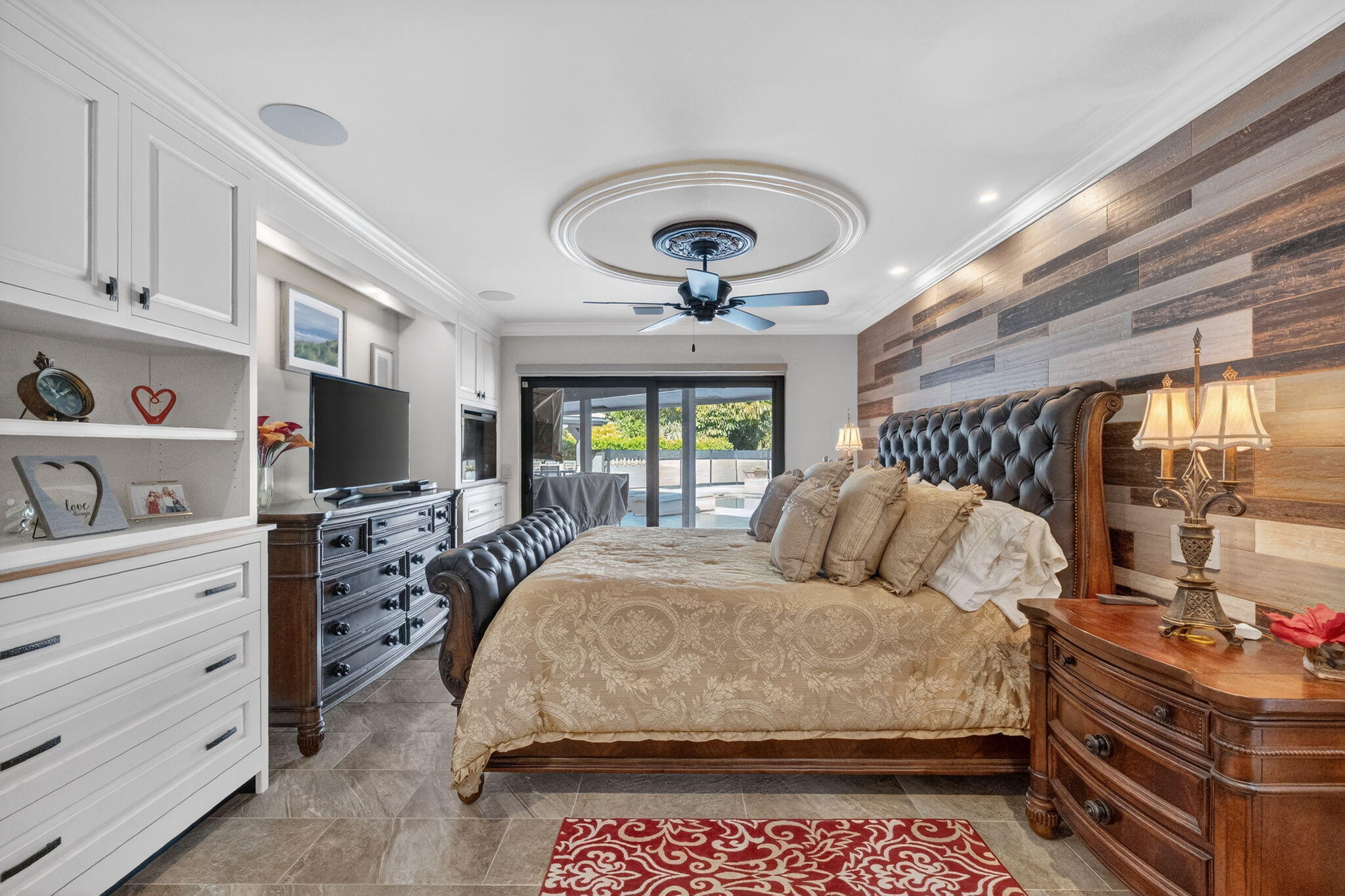 5212 Foxpointe Circle Delray Beach, FL 33445 - Photo 23 of 89 a bedroom with a bed and a flat tv screen