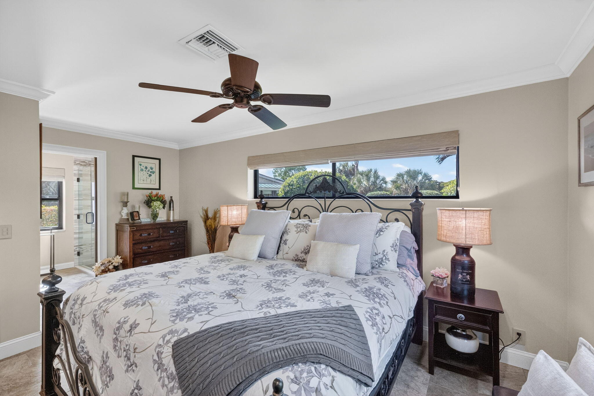 5212 Foxpointe Circle Delray Beach, FL 33445 - Photo 33 of 89 a bedroom with a bed and a chandelier