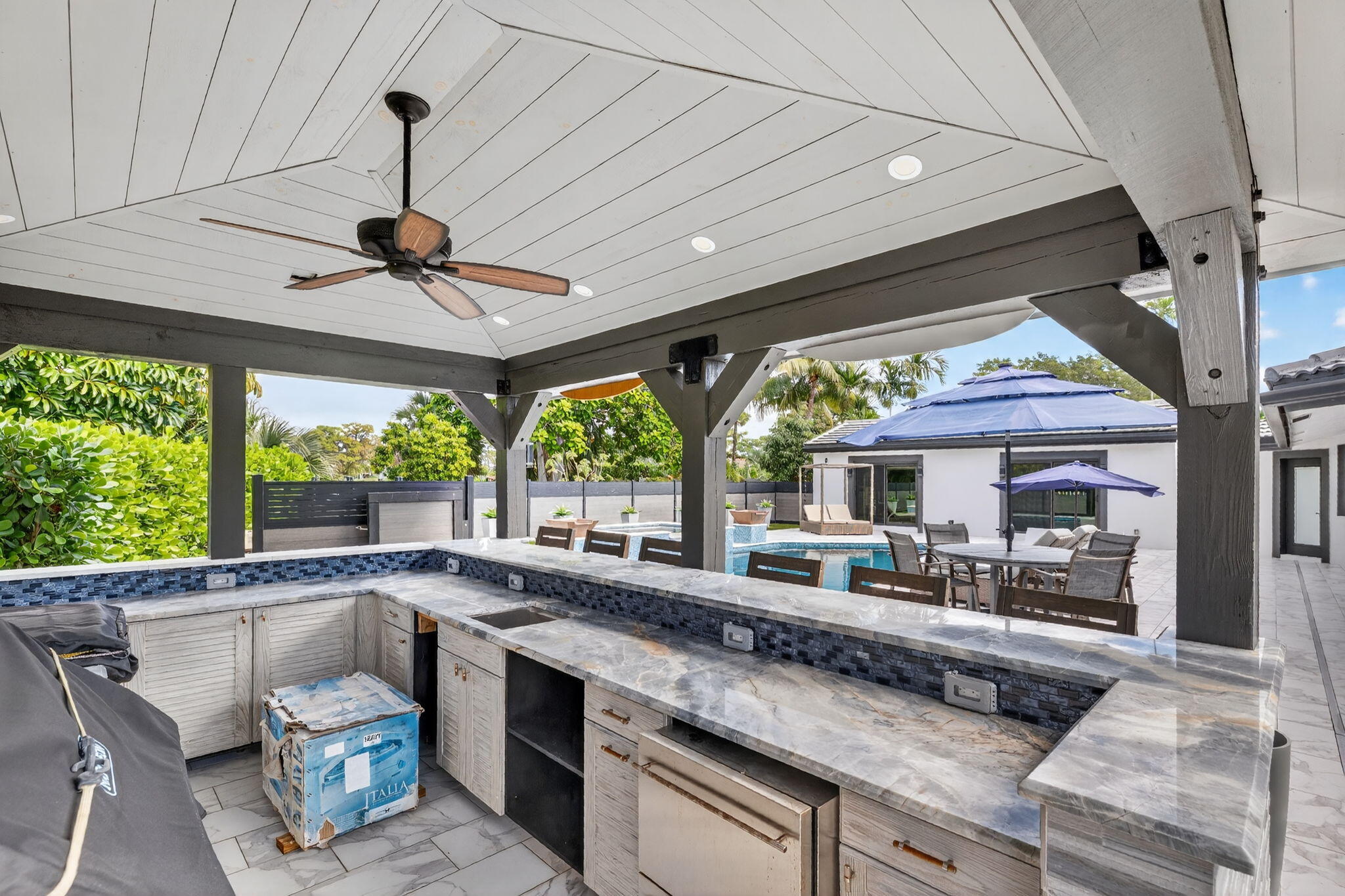 5212 Foxpointe Circle Delray Beach, FL 33445 - Photo 58 of 89 a open kitchen with stainless steel appliances granite countertop a sink a stove and a wooden floors