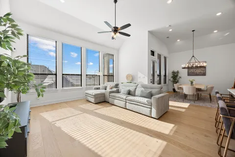 a living room with furniture and a potted plant