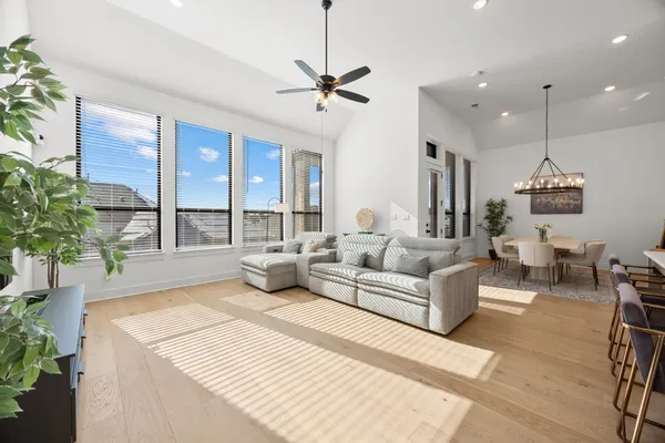 a living room with furniture and a potted plant