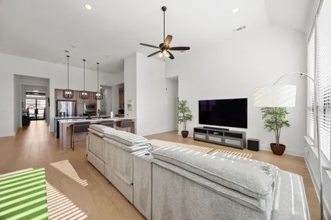 a kitchen with a counter top space a sink stainless steel appliances and cabinets