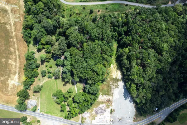 an aerial view of a forest with houses